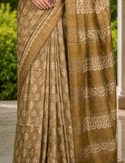 Close-up of an olive cotton silk Batik saree showing cream floral buti motifs and patterned pallu
