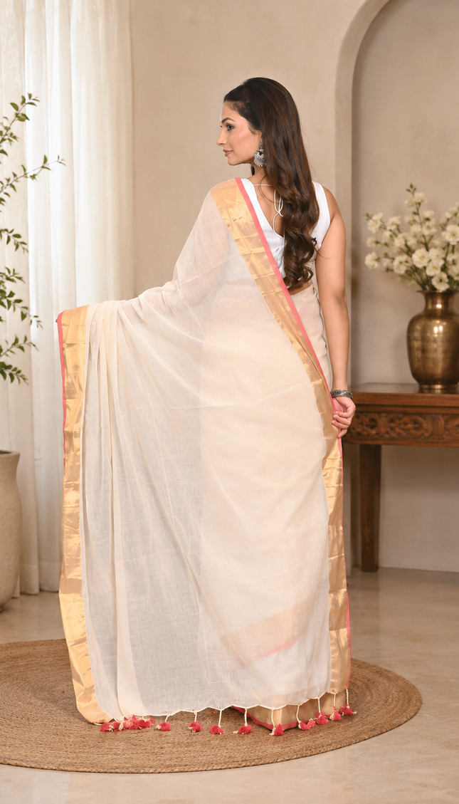 Back view of a woman wearing a white khadi saree with pink and yellow striped borders