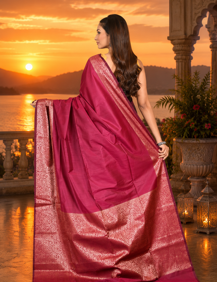 Magenta handwoven cotton zari saree back view with pallu spread showing rose-gold zari border.