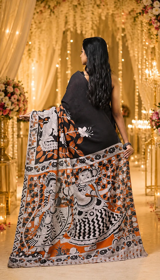 Black and rust Kalamkari digital print cotton saree back view with pallu spread showing Radha Krishna motifs
