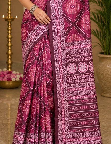 Close-up of magenta ikat silk saree pleats with white bandhani print and banded temple border - KalamKantha

