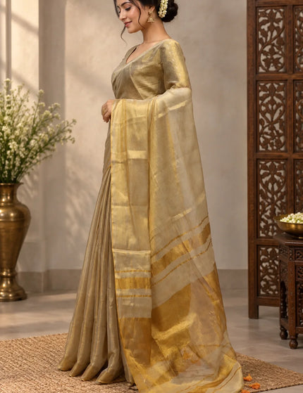 Side view of ivory Mull cotton saree showing golden pallu and orange tassels