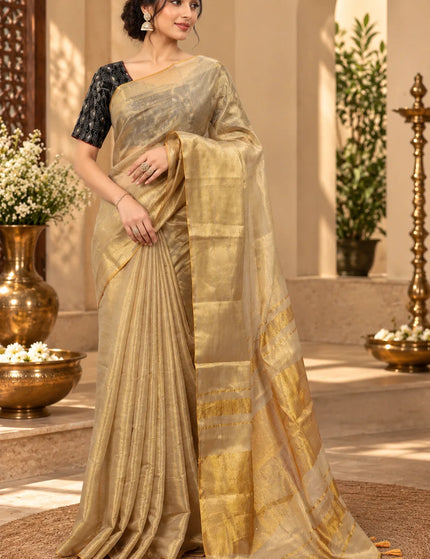 Front view of ivory Mull cotton saree with golden zari border and tasseled pallu