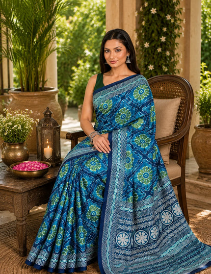 Teal ikkat silk saree draped seated, showing lustrous mercerised weave and printed pallu - KalamKantha