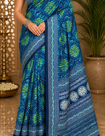 Close-up of teal ikkat silk saree pleats with green floral motifs and white circular border band - KalamKantha