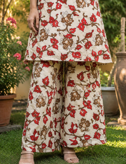 Close-up front view of the ivory kurti hem and wide-leg gol palazzo, showing the red and brown floral print